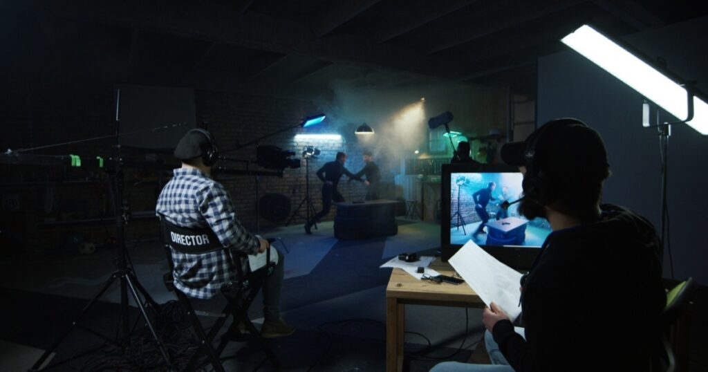 Director and crew with lighting and camera on film set