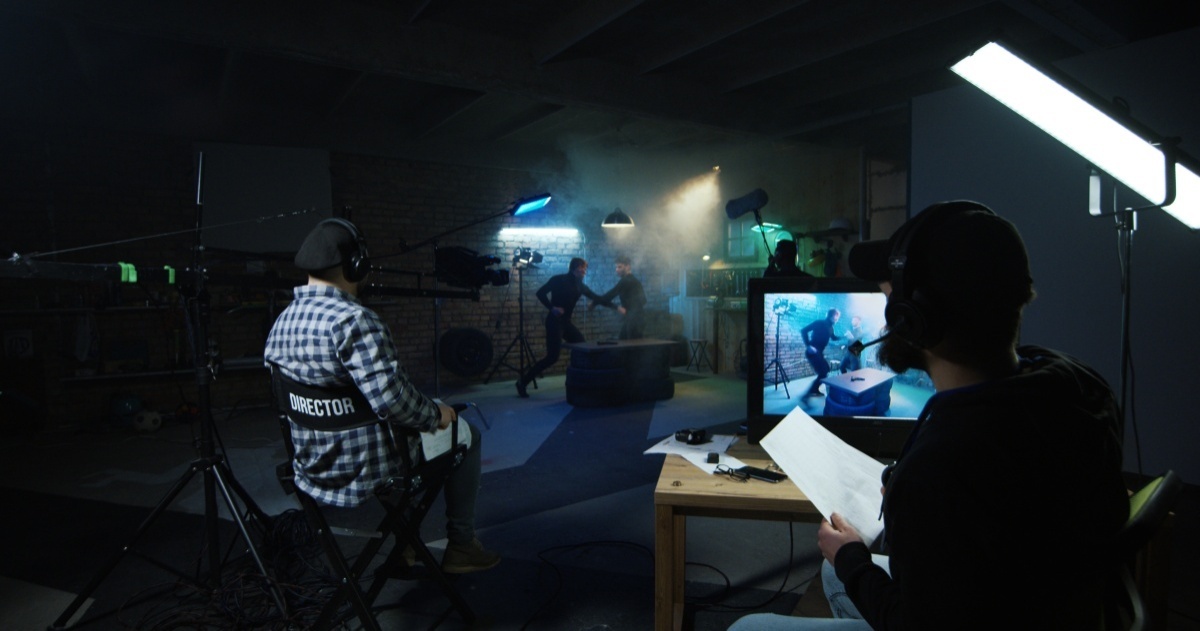 Director and crew with lighting and camera on film set