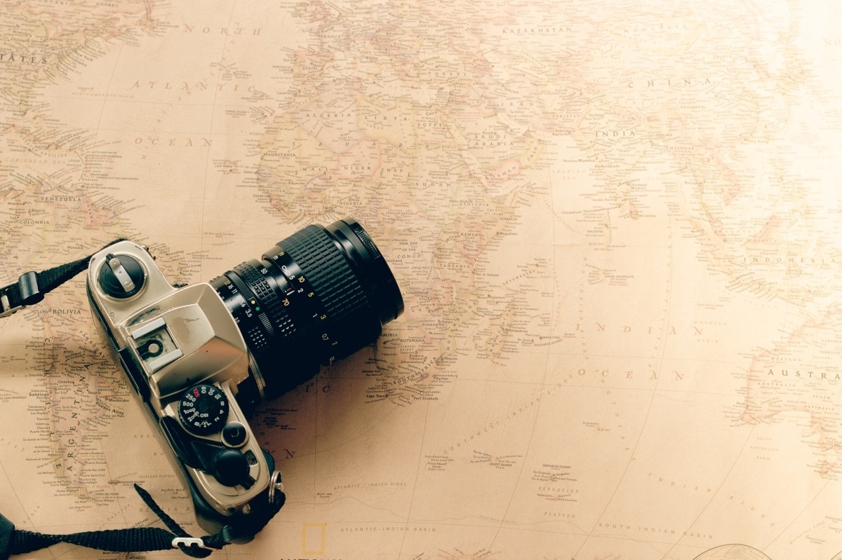 Vintage camera for film location scouting on world map