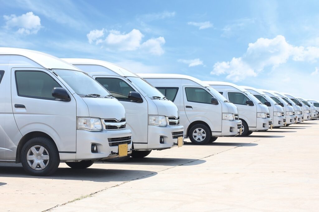 White vans lined up for film crew transport.